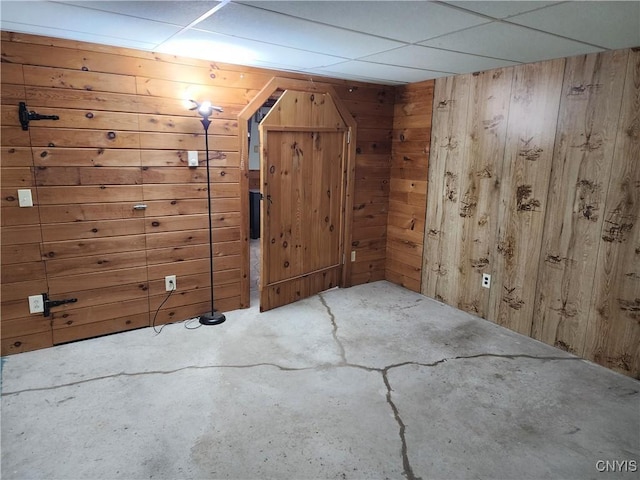 bonus room featuring wooden walls