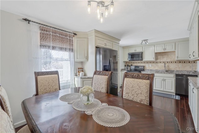 dining room with sink and dark hardwood / wood-style flooring