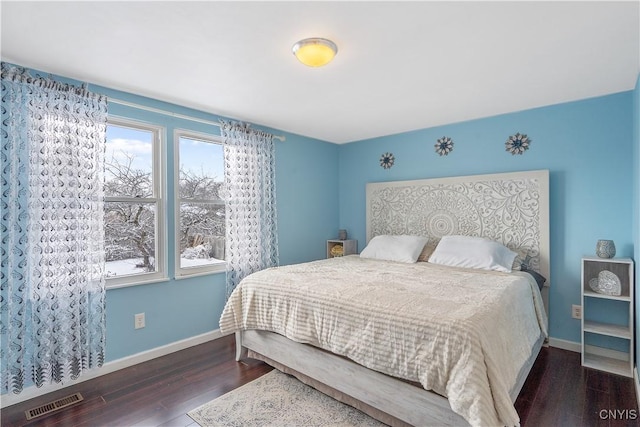 bedroom with dark hardwood / wood-style floors