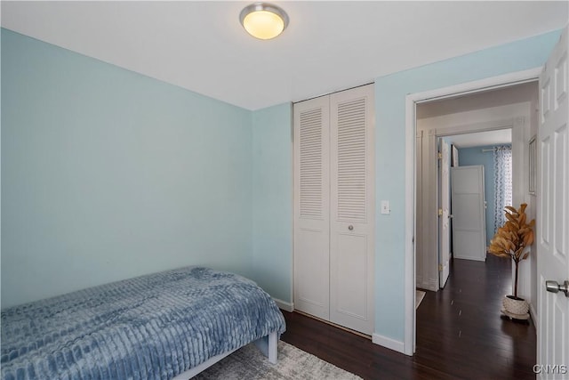 bedroom featuring a closet and dark hardwood / wood-style floors