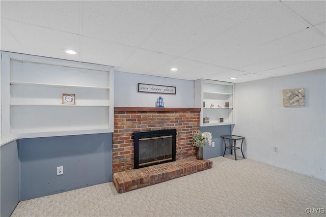 carpeted living room with a fireplace