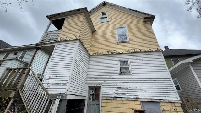 back of property with a balcony