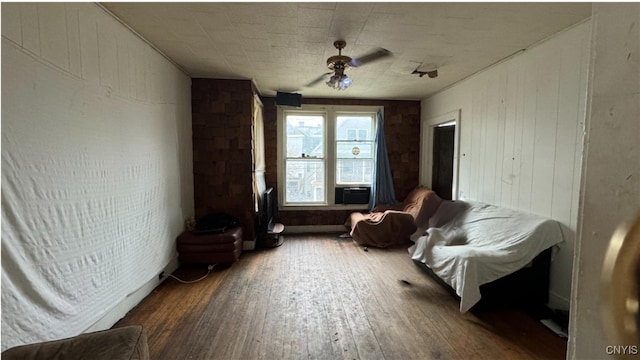 living area with hardwood / wood-style flooring and ceiling fan