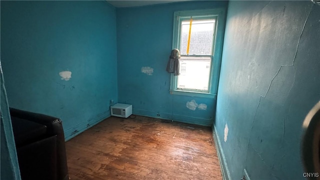 spare room featuring hardwood / wood-style flooring and a healthy amount of sunlight