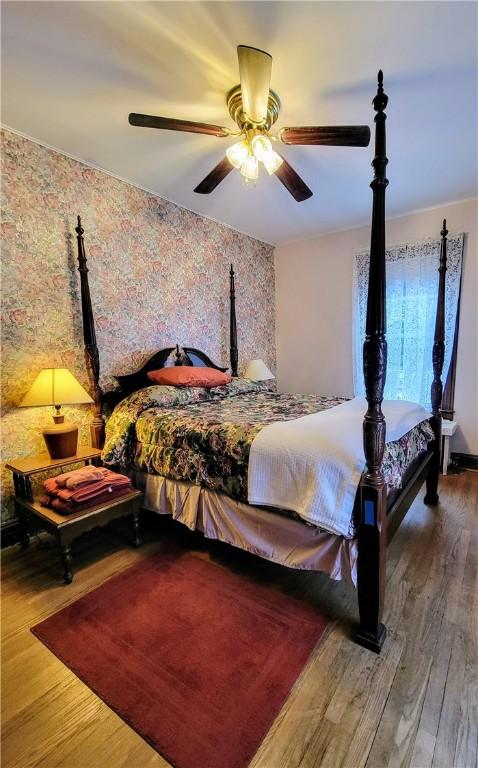 bedroom featuring ceiling fan and wood-type flooring