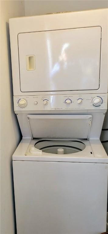 clothes washing area with stacked washer and dryer