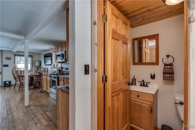 interior space featuring wood ceiling, sink, and hardwood / wood-style flooring