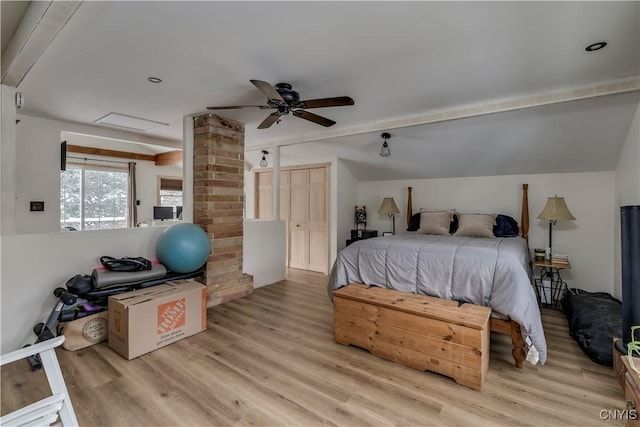 bedroom with ceiling fan, vaulted ceiling, and light hardwood / wood-style flooring