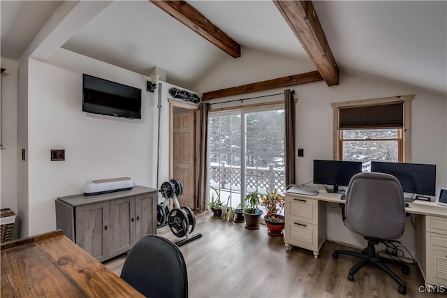 office area with lofted ceiling with beams, light hardwood / wood-style floors, and a healthy amount of sunlight