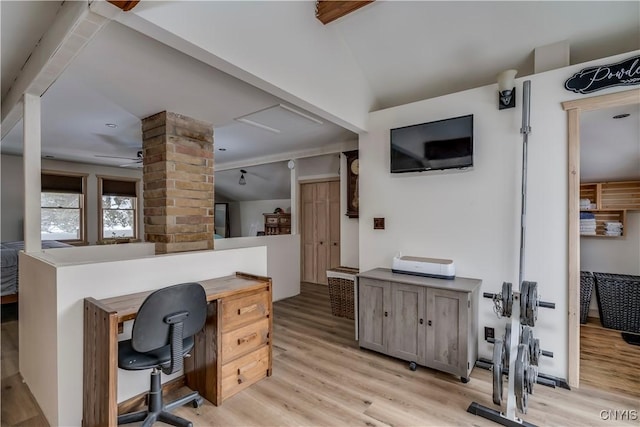 office space with decorative columns, lofted ceiling, ceiling fan, and light hardwood / wood-style flooring