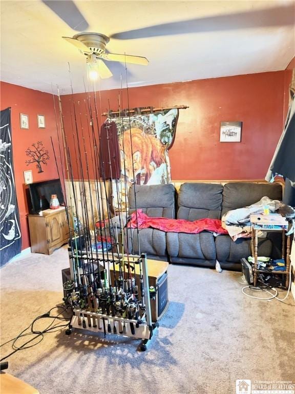 living room featuring carpet and ceiling fan