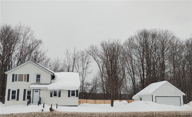 view of front facade featuring a garage and an outbuilding