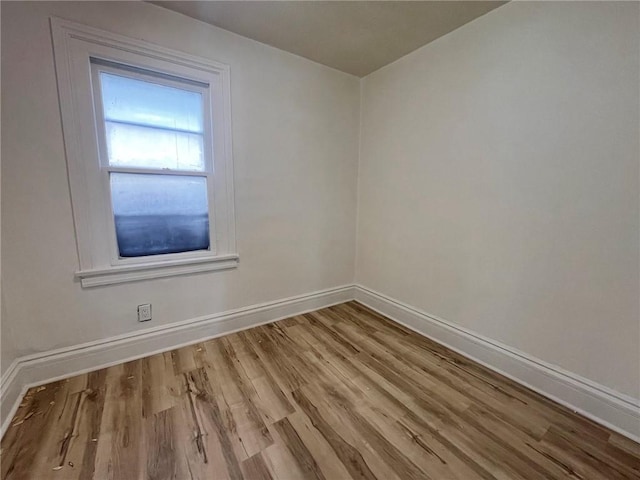 empty room with light hardwood / wood-style flooring