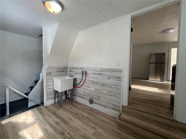 interior space featuring wood-type flooring and wooden walls