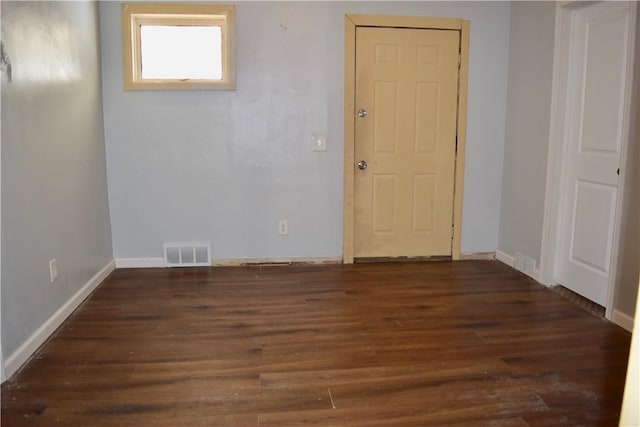 empty room with dark hardwood / wood-style flooring