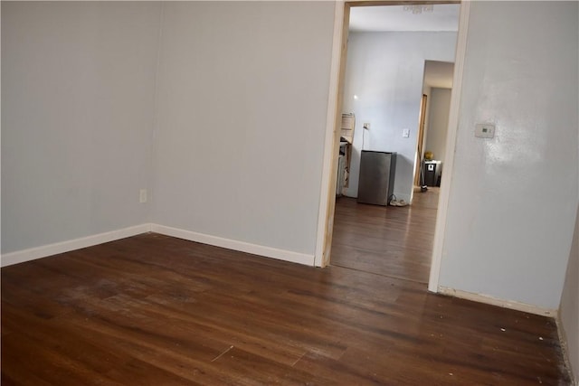 spare room with dark hardwood / wood-style floors