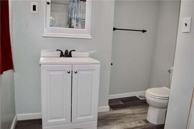 bathroom featuring hardwood / wood-style flooring, vanity, and toilet