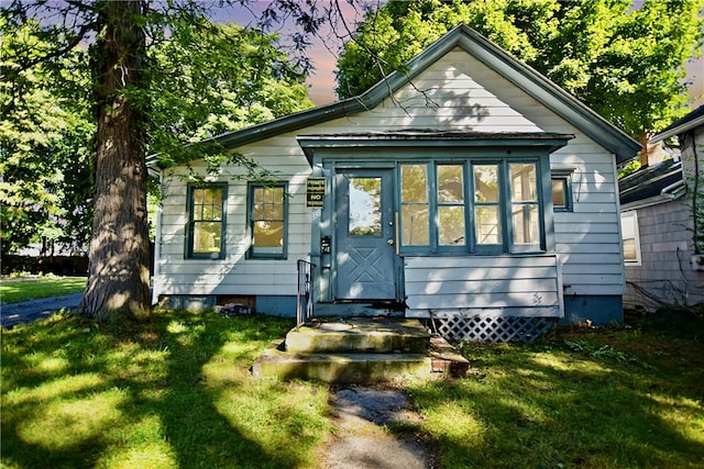 bungalow-style home featuring a yard