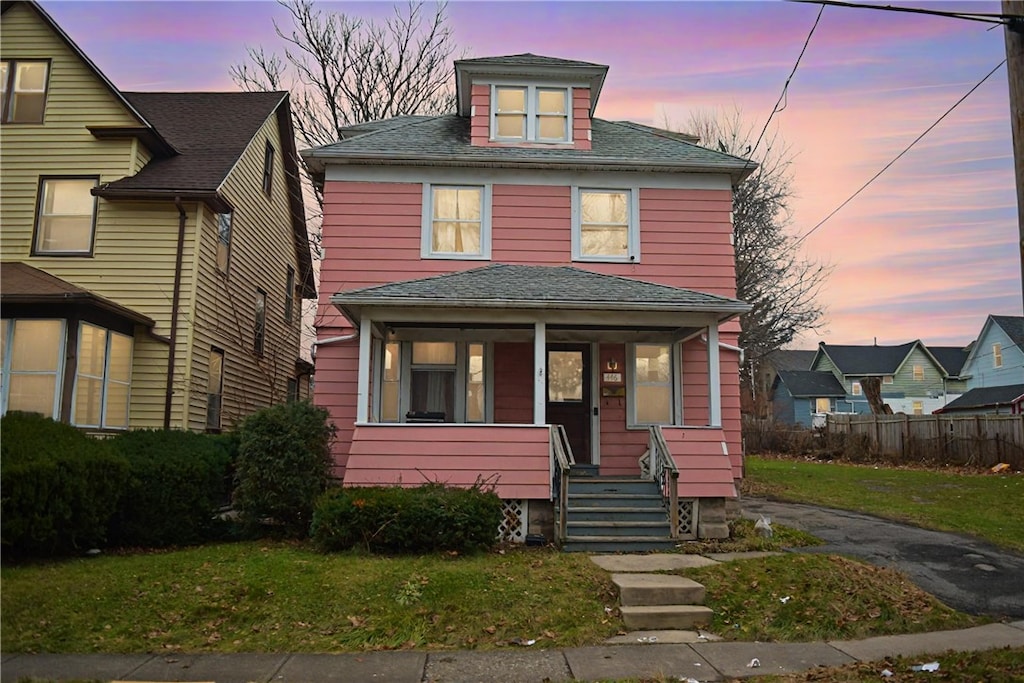 view of front facade featuring a yard and covered porch