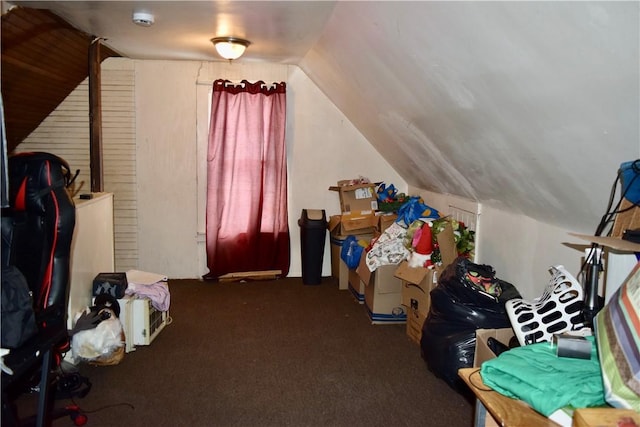 bonus room featuring lofted ceiling and dark carpet