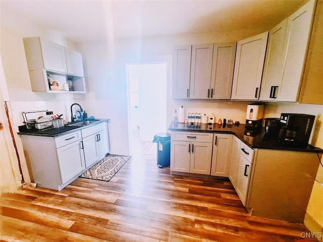 kitchen with sink, white cabinets, and light hardwood / wood-style floors