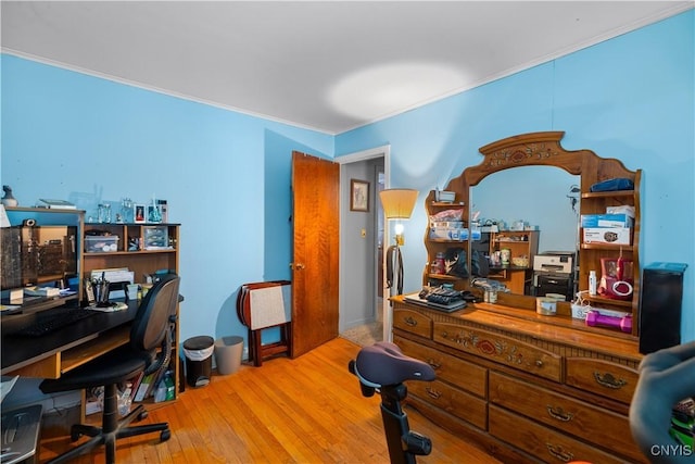 home office featuring crown molding and light wood-type flooring