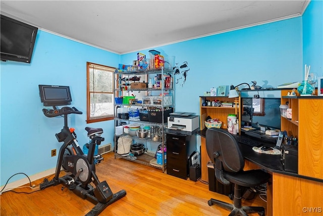 office area with crown molding and hardwood / wood-style flooring