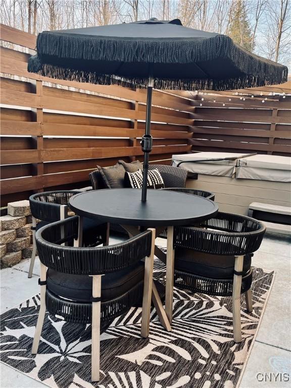 view of patio / terrace with a hot tub