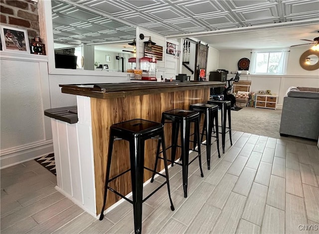 bar with light wood-type flooring