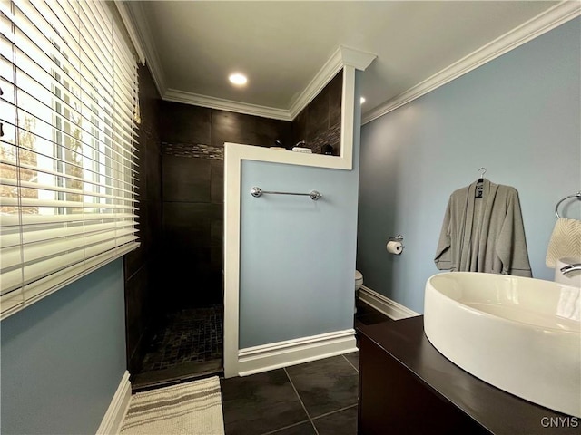 bathroom featuring sink, crown molding, tile patterned floors, toilet, and walk in shower