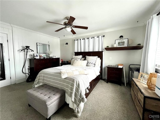 carpeted bedroom featuring ceiling fan and ornamental molding