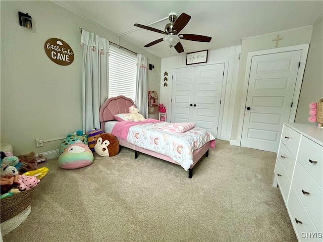 bedroom with ceiling fan, a closet, and light carpet