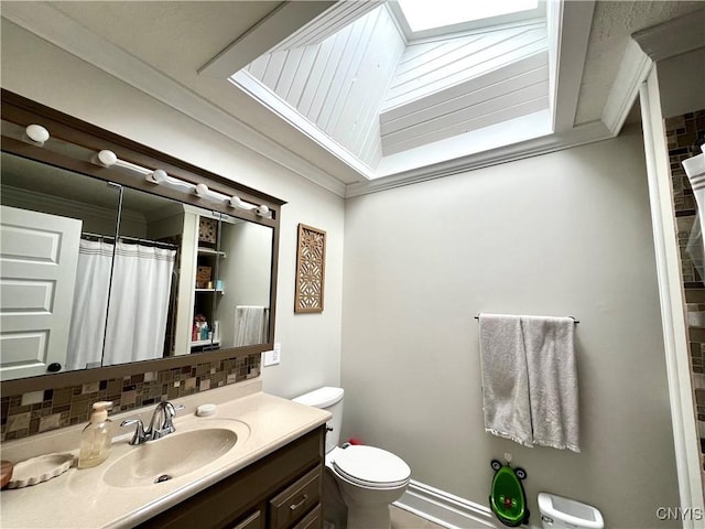 bathroom with crown molding, toilet, backsplash, and vanity