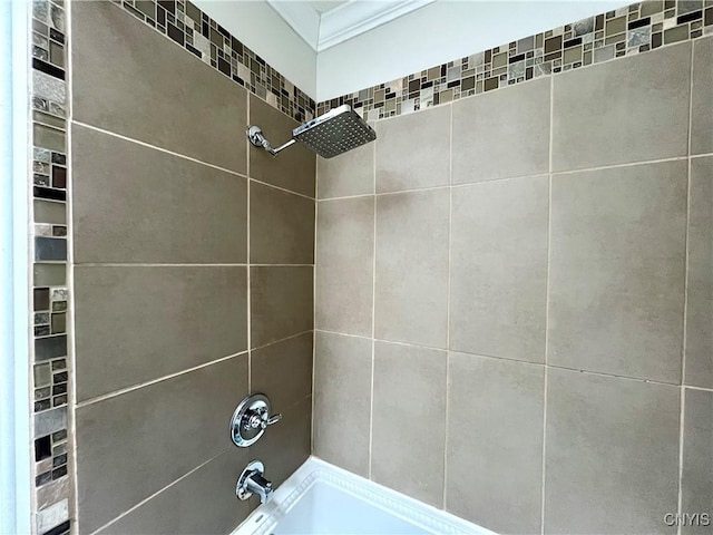 interior details with ornamental molding and tiled shower / bath