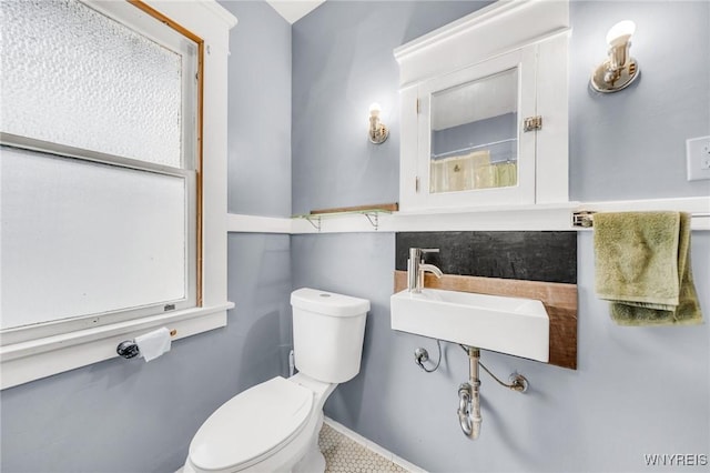 bathroom with plenty of natural light, sink, and toilet