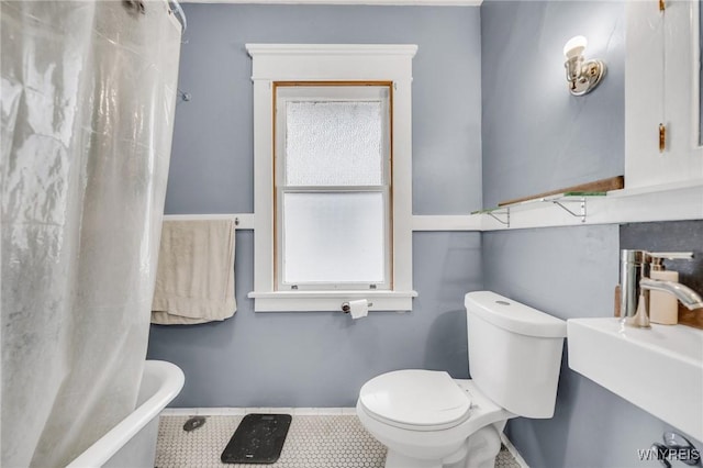 bathroom with sink, tile patterned floors, and toilet