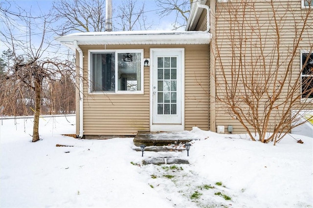 view of snow covered property entrance