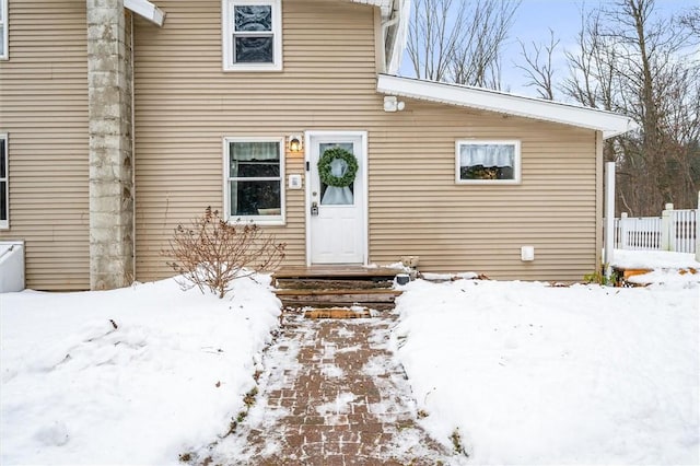 view of snow covered property entrance