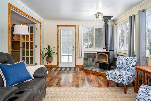 interior space featuring crown molding, hardwood / wood-style floors, and a wood stove