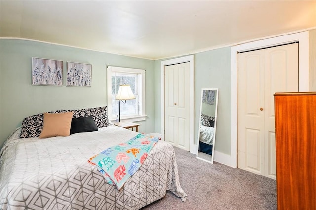 carpeted bedroom with multiple closets