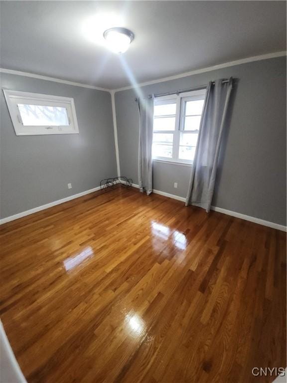 unfurnished room featuring crown molding and dark hardwood / wood-style flooring