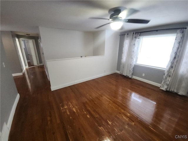 unfurnished room featuring dark hardwood / wood-style flooring and ceiling fan