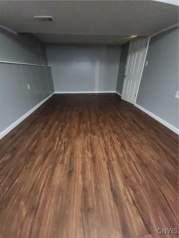 spare room with dark hardwood / wood-style flooring