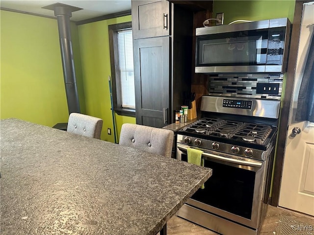 kitchen with tasteful backsplash and stainless steel appliances