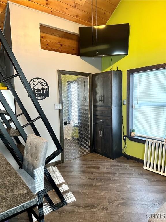 entrance foyer featuring vaulted ceiling, dark wood-type flooring, and wood ceiling