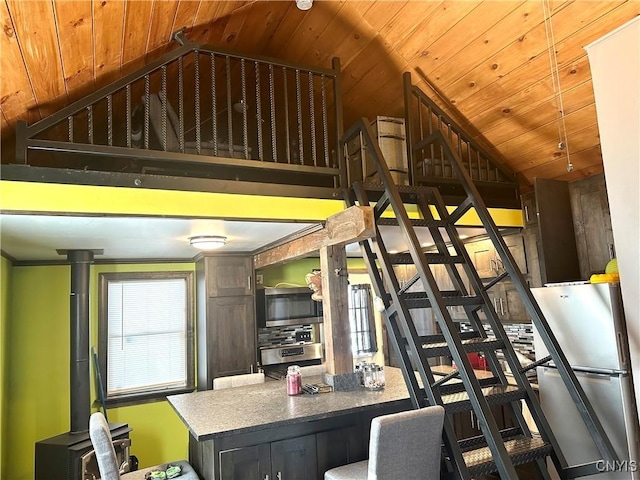 kitchen featuring stainless steel appliances, high vaulted ceiling, and wooden ceiling