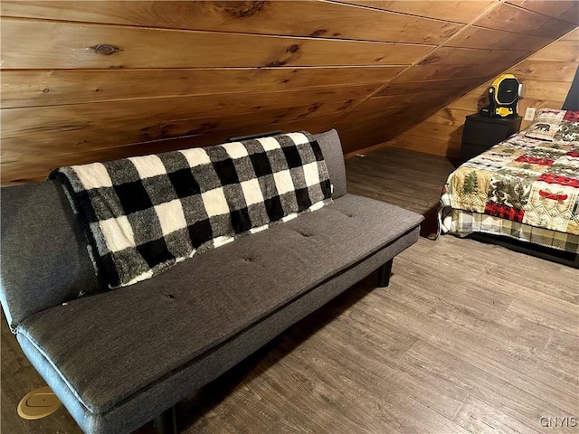 bedroom featuring hardwood / wood-style floors, wood ceiling, wooden walls, and vaulted ceiling