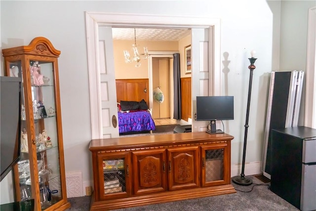 kitchen with pendant lighting, refrigerator, a chandelier, and carpet