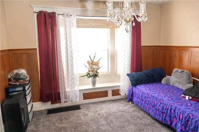 bedroom featuring an inviting chandelier and carpet floors