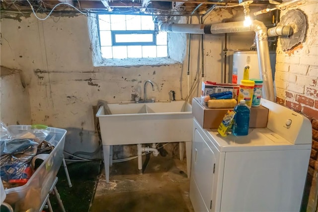 laundry room with water heater, separate washer and dryer, and sink